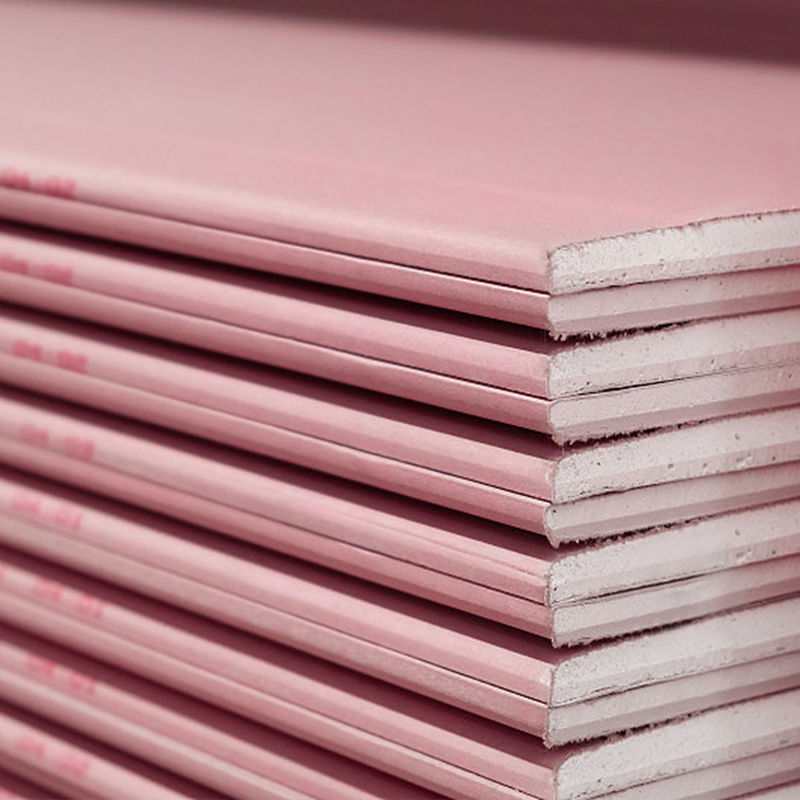 Unbranded stack of red-faced fire-resistant gypsum plasterboards